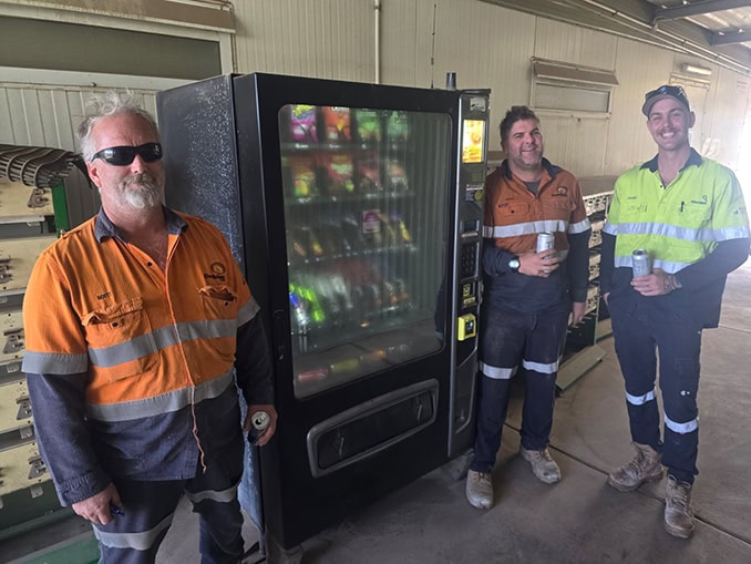 Mine site workers beside an A1 Vending snack and drink machine, mining vending machines in WA.