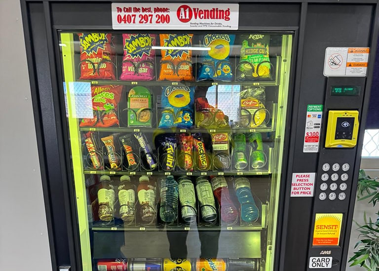 Mine site worker using tap-and-go cashless payment on an A1 Vending machine — vending machine services Kalgoorlie operations rely on