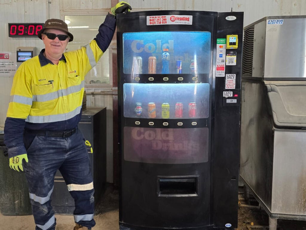 A1 Vending machine technician beside cashless vending machines on a WA worksite