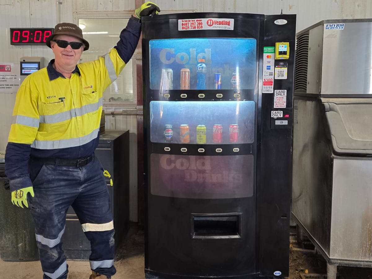 A1 Vending machine technician beside cashless vending machines on a WA worksite